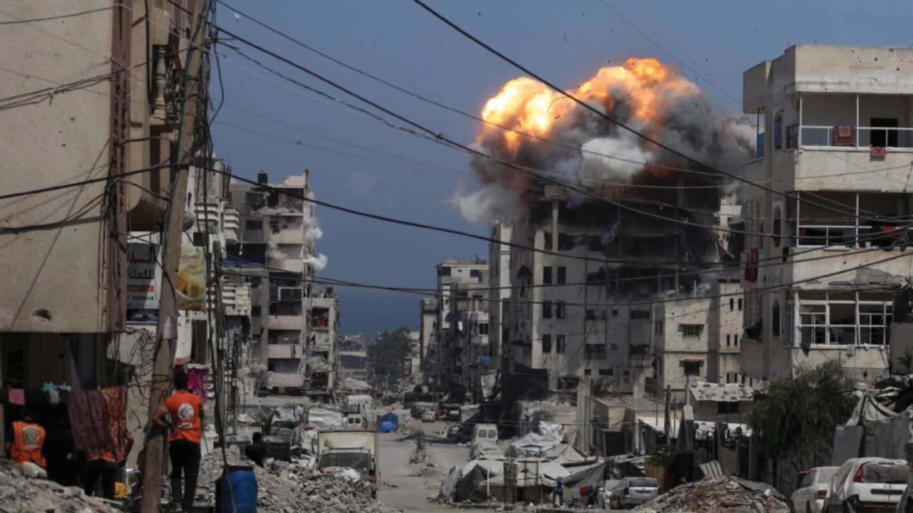 Smoke and flames rise from a residential building hit by an Israeli strike, in Gaza City July 21, ...