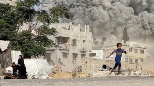 A girl runs from the scene after Israeli strikes on a school sheltering displaced people at the ... A girl runs from the scene after Israeli strikes on a school sheltering displaced people at the ...