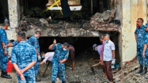 Bangladesh Air Force personnel inspect the crash site a day after a training jet crashed into a ... Bangladesh Air Force personnel inspect the crash site a day after a training jet crashed into a ...