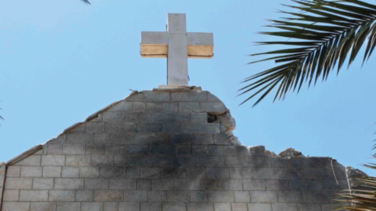 TOPSHOT - A picture shows a view of a damaged facade of the Holy Family Church, a day after it was ...