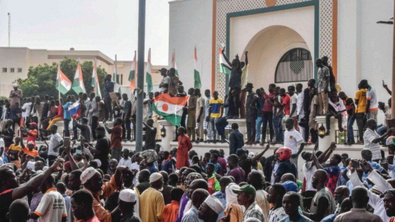 (FILES) Supporters wave Nigerien's flags as they rally in support of Niger's junta in front of the ...
