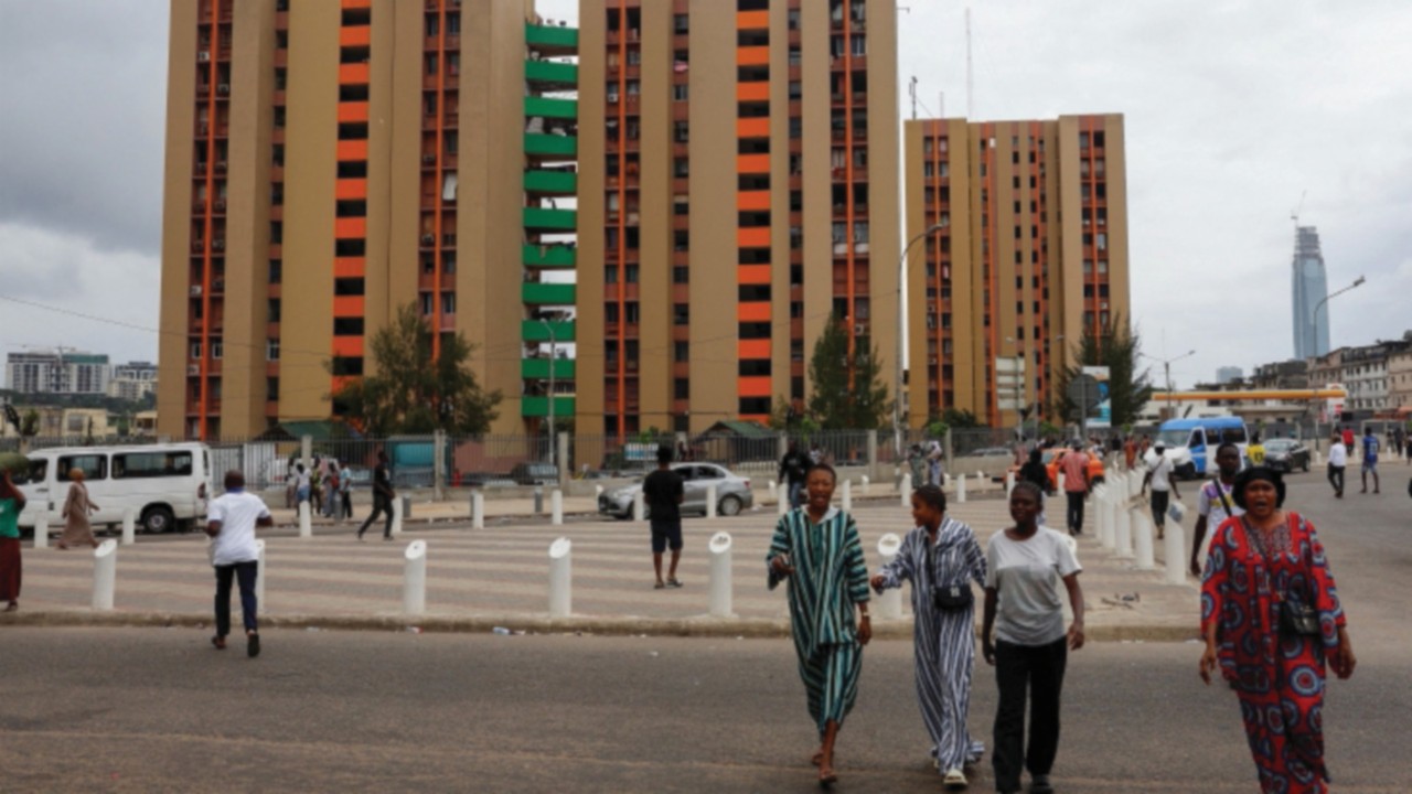 People walk on a street in Adjame, a district of Abidjan, Ivory Coast July 13, 2025. REUTERS/Luc ...