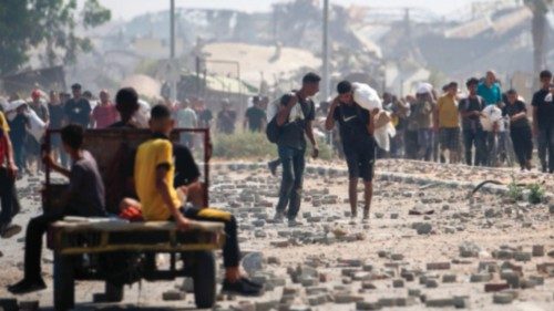 Displaced Palestinians at the Nuseirat refugee camp haul food parcels and other items they managed ...
