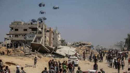 epa12265620 Humanitarian aid airdropped by the Royal Jordanian Army lands in the northern Gaza ...