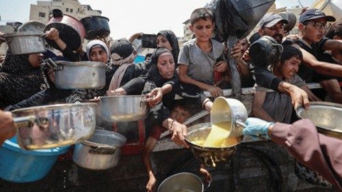 Palestinians gather to receive food from a charity kitchen, amid a hunger crisis, in Gaza City, July ... Palestinians gather to receive food from a charity kitchen, amid a hunger crisis, in Gaza City, July ...