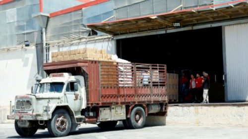 Workers load aid boxes onto a truck at a World Food Programme (WFP) facility in Damascus ... Workers load aid boxes onto a truck at a World Food Programme (WFP) facility in Damascus ...
