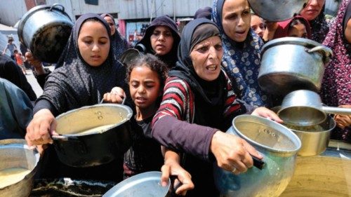 Displaced Palestinians receive lentil soup at a food distribution point in Gaza City in the northern ... Displaced Palestinians receive lentil soup at a food distribution point in Gaza City in the northern ...