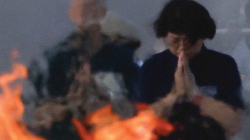 People pray in front of the cenotaph for the victims of the 1945 atomic bombing, at the Peace ...