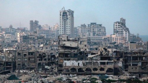 Tents used as temporary shelters by displaced Palestinians are set up near war-damaged buildings in ... Tents used as temporary shelters by displaced Palestinians are set up near war-damaged buildings in ...