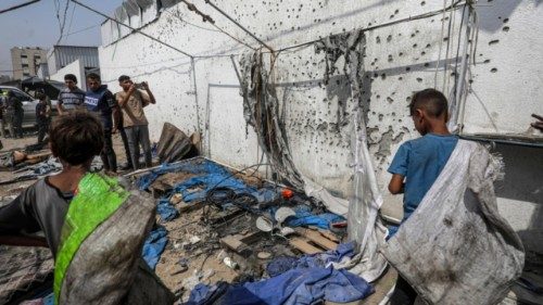 epa12293400 Palestinians inspect the destroyed tent of the Al Jazeera team following an Israeli ...