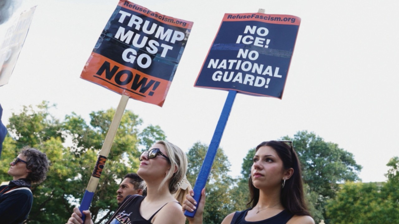 Women display signs as people protest at Dupont Circle after U.S. President Donald Trump announced ...