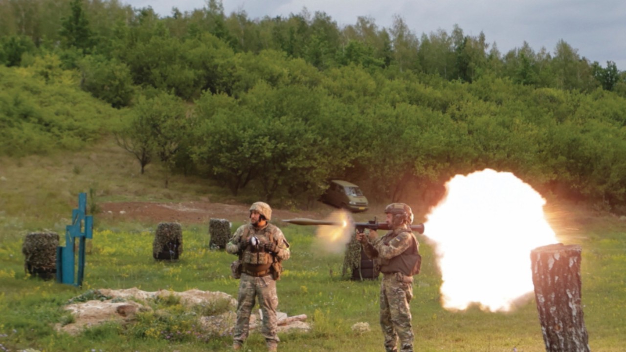 Service members of the 58th Separate Motorized Infantry Brigade of the Ukrainian Armed Forces use an ...