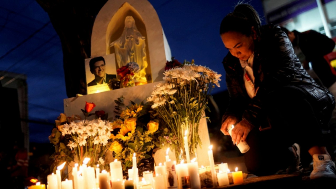 People light candles at a memorial set up at the site where Colombian Senator Miguel Uribe Turbay ...