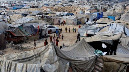 Palestinians, displaced by the Israeli offensive, shelter in a tent camp on a beach amid summer heat ...
