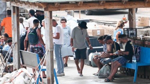 Migrants are guided after disembarking on the Italian island of Lampedusa following their rescue ... Migrants are guided after disembarking on the Italian island of Lampedusa following their rescue ...