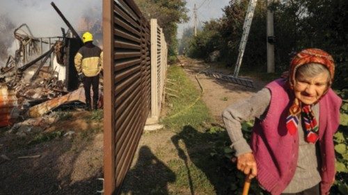 A resident walks along a street as a firefighter works at the site of a Russian missile strike, amid ... A resident walks along a street as a firefighter works at the site of a Russian missile strike, amid ...