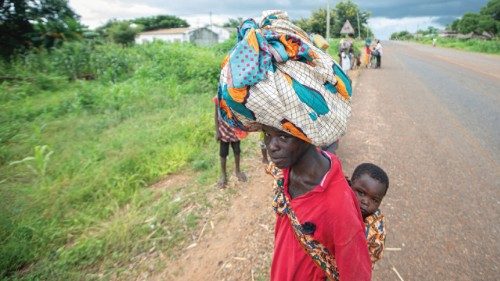 Displaced people from the province of Cabo Delgado walk through the streets of Namapa, Erati ...