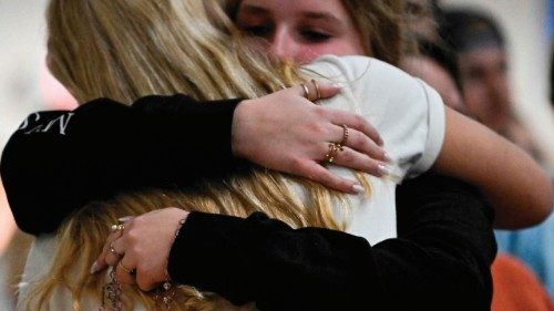 RICHFIELD, MINNESOTA - AUGUST 27: Attendees embrace at a vigil following a mass shooting at ... RICHFIELD, MINNESOTA - AUGUST 27: Attendees embrace at a vigil following a mass shooting at ...