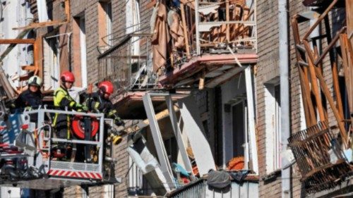 Rescuers clear debris in a residential building in a damaged area of Ukranian capital following a ... Rescuers clear debris in a residential building in a damaged area of Ukranian capital following a ...