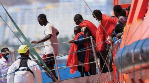 Migrants disembark from a Spanish coast guard vessel at the port of Arguineguin, on the island of ... Migrants disembark from a Spanish coast guard vessel at the port of Arguineguin, on the island of ...