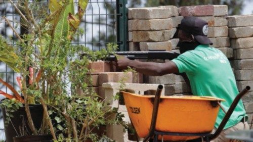A member of a community security force takes up a position behind a wall as gunshots are heard after ... A member of a community security force takes up a position behind a wall as gunshots are heard after ...