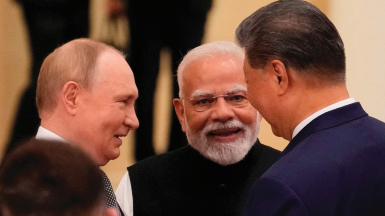 Indian Prime Minister Narendra Modi (C) talks with Russian President Vladimir Putin (L) and Chinese ...
