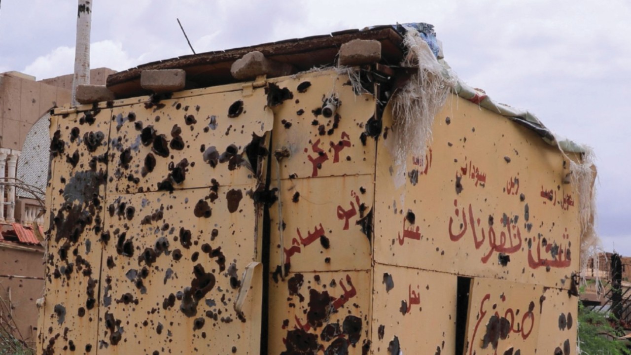 A newspaper stand with signs of heavy gunfire during a tour with Sudanese journalist Shamael Elnoor ...
