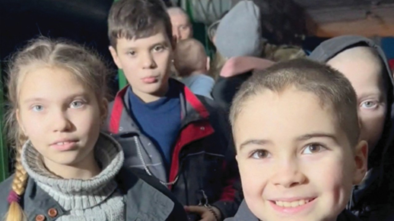 Children react as they take shelter, amid Russia's invasion of Ukraine, in a bunker said by ...