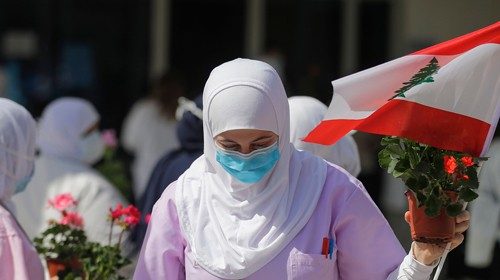 A Lebanese nurse receives flowers on the occasion of International Nurses Day at the Rafik Hariri ...