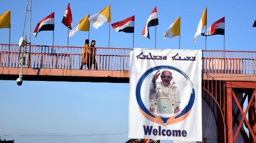 epa09044220 A view shows Iraqi and Vatican flags and the picture of Pope Francis at the Assyrian ...