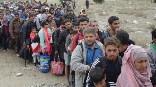 Hundreds of migrant line-up to catch a train near Gevgelija, Macedonia, September 7, 2015.  Several ...