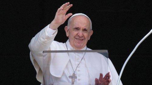 Pope Francis raises his hand in greeting as he delivers the Angelus hours before being admitted to ...