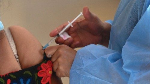 An indigenous woman receives a dose of the Moderna vaccine against COVID-19, donated by the US, at a ...