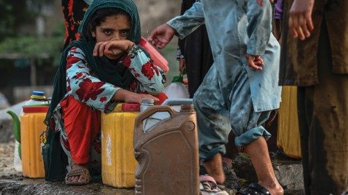 Children fill water from a tap installed along a road in Kabul on July 11, 2021. (Photo by SAJJAD ...