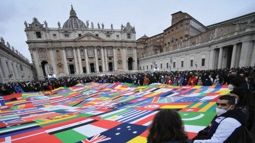 Faithfuls hold a banner made of the world flags as Pope Francis delivers a prayer for the migrants ...