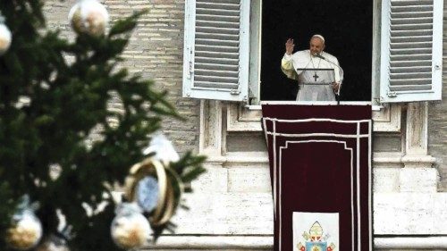 Pope Francis waves to worshippers as he holds an Angelus prayer from the window of the apostolic ...