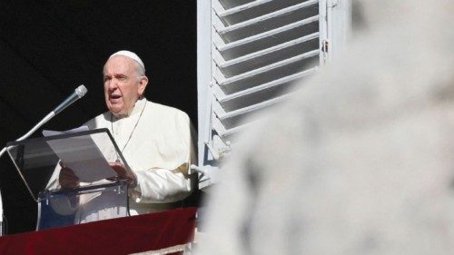 Pope Francis addresses attendees from the window of the apostolic palace overlooking St. Peter's ...