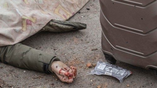 epa09806183 The body of a civilian who was killed while attempting to flee the city lies covered ... epa09806183 The body of a civilian who was killed while attempting to flee the city lies covered ...