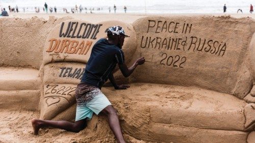 South African sand sculptor Sithembiso Buthelezi gives the final touches showing a message calling ...