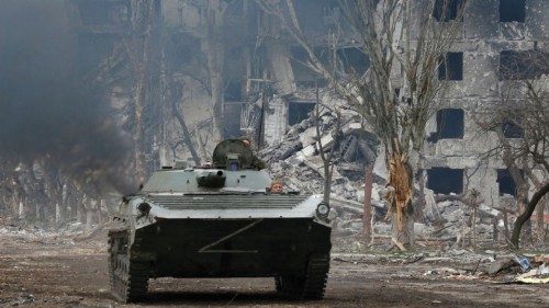 Service members of pro-Russian troops ride an armoured vehicle during fighting in Ukraine-Russia ...