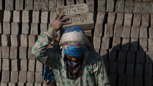 epa09664167 Migrant workers at a brick factory in Pharping, on the outskirts of Kathmandu, Nepal, 03 ...