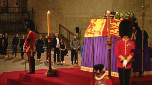 Members of the public file past as soldiers of The Grenadier Guards and Yeomen of the Guard, stand ... Members of the public file past as soldiers of The Grenadier Guards and Yeomen of the Guard, stand ...