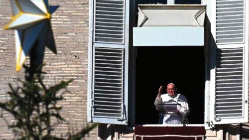 Pope Francis waves at the crowd from the window of the apostolic palace overlooking St. Peter's ...