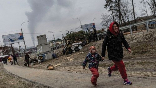 Local residents run for cover as they escape from the town of Irpin, after heavy shelling on the ...