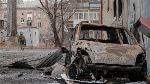 A Ukrainian serviceman walks an empty street as he patrols area, as Russia's attack on Ukraine ...