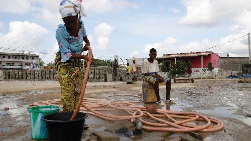 epa10535365 A woman fills a bucket with borehole water, a day before the day designated as World ...