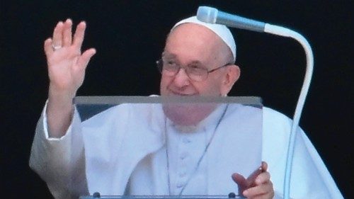 Pope Francis waves from the window of the apostolic palace overlooking St. Peter's square during the ...