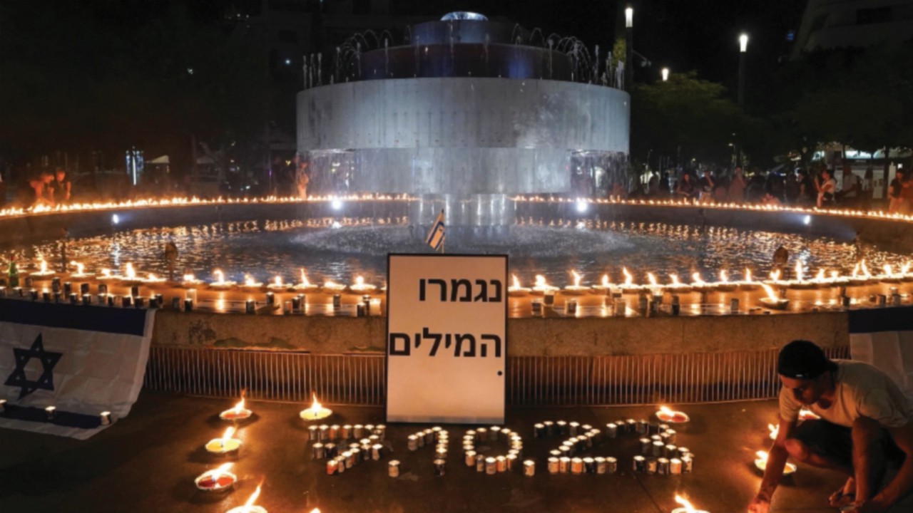 People gather and light candles to show solidarity with Israel and remember the victims following an ...