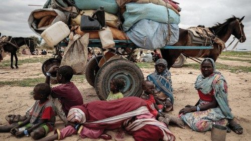 FILE PHOTO: A Sudanese family who fled the conflict in Murnei in Sudan's Darfur region, sit beside ...