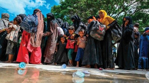 Newly-arrived Rohingya refugees wait to board trucks to transfer to a temporary shelter after ... Newly-arrived Rohingya refugees wait to board trucks to transfer to a temporary shelter after ...